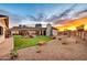 Expansive backyard boasts a stunning rock waterfall, playset, and desert landscaping at 4022 E Stanford Dr, Phoenix, AZ 85018