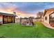 Beautiful backyard featuring a unique rock waterfall feature and lush artificial turf at 4022 E Stanford Dr, Phoenix, AZ 85018