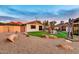 Beautiful backyard featuring a unique rock waterfall and lush artificial turf at 4022 E Stanford Dr, Phoenix, AZ 85018