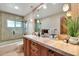 Bathroom with a shower-tub combo, a marble countertop, pendant lights and neutral mosaic tile detail at 4022 E Stanford Dr, Phoenix, AZ 85018