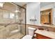 Bathroom with a walk-in shower featuring a glass door and ceramic tile and a wood vanity at 4022 E Stanford Dr, Phoenix, AZ 85018