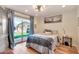 Bedroom featuring natural light with a sliding glass door that offers a view of the landscaped backyard at 4022 E Stanford Dr, Phoenix, AZ 85018