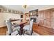 Charming dining area with a brick fireplace, hardwood floors, and stylish furnishings at 4022 E Stanford Dr, Phoenix, AZ 85018
