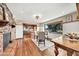 Cozy dining area with brick fireplace and a window view of the landscaped yard at 4022 E Stanford Dr, Phoenix, AZ 85018