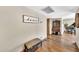 Inviting hallway with hardwood floors, a decorative bench, and stylish home decor at 4022 E Stanford Dr, Phoenix, AZ 85018