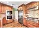 Spacious kitchen featuring stainless steel appliances and custom cabinets at 4022 E Stanford Dr, Phoenix, AZ 85018