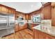 Modern kitchen with stainless steel appliances, granite countertops, and custom wood cabinetry at 4022 E Stanford Dr, Phoenix, AZ 85018