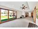 Spacious living room with backyard view, carpet floor, ceiling fan, and natural light at 4022 E Stanford Dr, Phoenix, AZ 85018