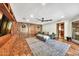 A view of the living room featuring tile floors, wood paneled walls, and an area rug at 4022 E Stanford Dr, Phoenix, AZ 85018