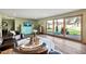 Bright and airy living room with a glass coffee table and sliding glass doors to the backyard patio at 4022 E Stanford Dr, Phoenix, AZ 85018