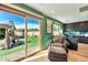 Bright home office with built-in shelves, a desk, and a tranquil view of a stone fountain at 4022 E Stanford Dr, Phoenix, AZ 85018