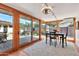 Bright sun room featuring tile flooring, a black dining set, and glass sliding doors to the patio at 4022 E Stanford Dr, Phoenix, AZ 85018