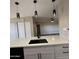 Modern kitchen island with white cabinets and black sink at 409 W Pontiac Dr # 8, Phoenix, AZ 85027