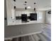 Modern kitchen with white cabinets, quartz countertops, and black appliances at 409 W Pontiac Dr # 8, Phoenix, AZ 85027