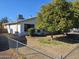 View of home's side, showcasing yard and fence at 4132 N 89Th Ln, Phoenix, AZ 85037