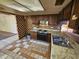 View of kitchen with wood cabinets and tile floors at 4132 N 89Th Ln, Phoenix, AZ 85037