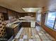 Kitchen features wood cabinets, tile floors and appliances at 4132 N 89Th Ln, Phoenix, AZ 85037