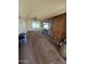 Open living area with wood-paneled walls and carpet at 4132 N 89Th Ln, Phoenix, AZ 85037