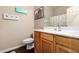 Traditional bathroom with wood vanity, toilet, decorative accents, and a shower-tub combo at 42424 N Gavilan Peak Pkwy # 23102, Anthem, AZ 85086