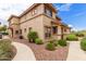 Inviting two-story home with desert landscaping, pathway, and neutral-toned stucco exterior at 42424 N Gavilan Peak Pkwy # 23102, Anthem, AZ 85086