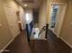 Upstairs hallway featuring wood floors, a railing, and doors to various rooms at 42424 N Gavilan Peak Pkwy # 23102, Anthem, AZ 85086