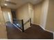 Upper level hallway with modern railing and doors to bedrooms and bathrooms at 42424 N Gavilan Peak Pkwy # 23102, Anthem, AZ 85086