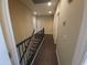 Upstairs hallway featuring a black railing, and views of the downstairs staircase at 42424 N Gavilan Peak Pkwy # 23102, Anthem, AZ 85086