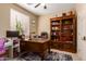 Home office space with large wooden desk, bookshelves, and natural light at 42424 N Gavilan Peak Pkwy # 23102, Anthem, AZ 85086