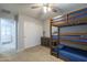 Bedroom with bunk beds, dresser, and access to another room at 4627 S Grenoble Cir, Mesa, AZ 85212