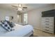 Main bedroom with a dresser, ceiling fan, and ensuite bathroom at 4627 S Grenoble Cir, Mesa, AZ 85212