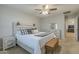 Main bedroom with light wood platform bed, dresser, and ceiling fan at 4627 S Grenoble Cir, Mesa, AZ 85212