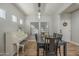 Elegant dining area with a black table, white piano, and striped runner at 4627 S Grenoble Cir, Mesa, AZ 85212