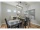 Bright dining room featuring a table for six and a stylish light fixture at 4627 S Grenoble Cir, Mesa, AZ 85212