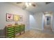 Upstairs hallway with green toy storage and playful wall art at 4627 S Grenoble Cir, Mesa, AZ 85212