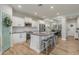 Modern kitchen with white cabinets, stainless steel appliances, and an island at 4627 S Grenoble Cir, Mesa, AZ 85212