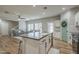 Kitchen features a large island, white cabinets and a view of the living room at 4627 S Grenoble Cir, Mesa, AZ 85212