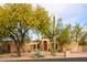 House exterior with mature trees and cacti at 4706 E Rancho Caliente Dr, Cave Creek, AZ 85331