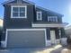 Two-story house featuring gray siding, a two-car garage, and landscaping at 47665 W Cansados Rd, Maricopa, AZ 85139