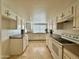 Kitchen with white cabinets, tile flooring, and appliances at 4829 E Lake Point Cir, Phoenix, AZ 85044