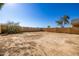 Large, open backyard with dirt and block wall at 5211 W Maldonado Rd, Laveen, AZ 85339