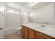 Clean bathroom with tub, sink, and wood cabinets at 5211 W Maldonado Rd, Laveen, AZ 85339