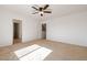 Spacious bedroom with ceiling fan and carpet flooring at 5211 W Maldonado Rd, Laveen, AZ 85339