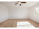 Bright bedroom with ceiling fan and window at 5211 W Maldonado Rd, Laveen, AZ 85339