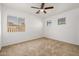 Spacious bedroom with ceiling fan and large window at 5211 W Maldonado Rd, Laveen, AZ 85339