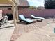 Spacious patio with lounge chairs and fire pit at 5725 E Good Pasture Ln, Florence, AZ 85132