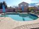 Beautiful kidney-shaped pool with patio and umbrellas at 5725 E Good Pasture Ln, Florence, AZ 85132