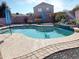 Sparkling kidney-shaped pool with surrounding patio at 5725 E Good Pasture Ln, Florence, AZ 85132