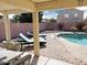 Relaxing pool area with lounge chairs and fire pit at 5725 E Good Pasture Ln, Florence, AZ 85132