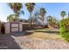 Large backyard with grass, gravel, shed, and mature trees at 581 W Reeves Ave, San Tan Valley, AZ 85140