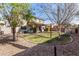 Spacious backyard with grassy area and mature trees at 581 W Reeves Ave, San Tan Valley, AZ 85140